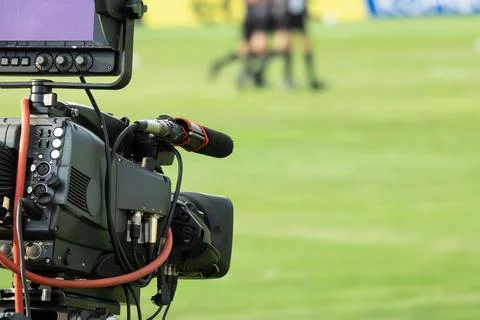 TV camera at the stadium, broadcasting during a football, soccer match Stock Photos