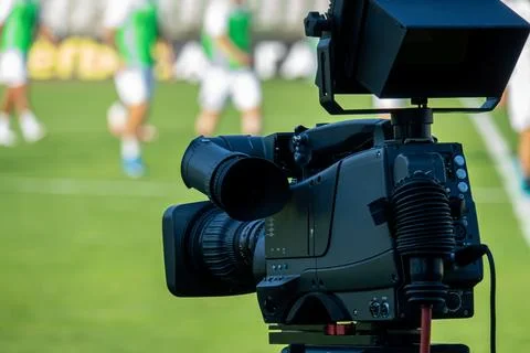 TV camera at the stadium, broadcasting during a football, soccer match Stock-Fotos
