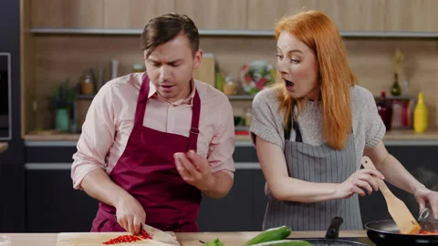 TV cooking show host pretended he cut a finger, laughing together with colleague Stock Footage 130813307