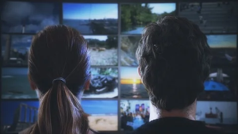 TV Couple Watching Multi Screen Television Video stock 99654370