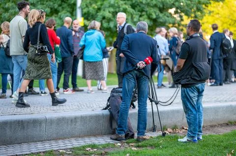 A TV crew filming in front of a queue of people in Jubilee Gardens on South Bank Stock Photos