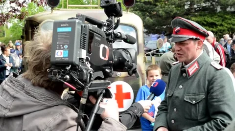 TV doing an interview with a soldier (Wo... | Stock Video | Pond5