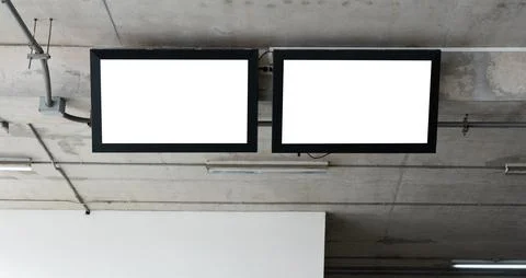 TV flat screen lcd with white blank monitor mockup hanging on the wall. Stock Photos