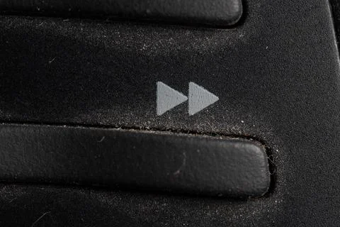 Tv forward icon and button close up of a old black Television remote controll Stock Photos