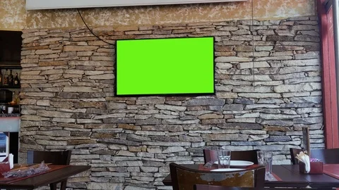TV with Green Screen mounted on Wall at an Empty Bar in Buenos Aires. 4K. Stock Footage 122228095