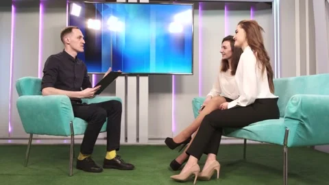 Tv host on talk show with two women guests Stock Footage 156962553