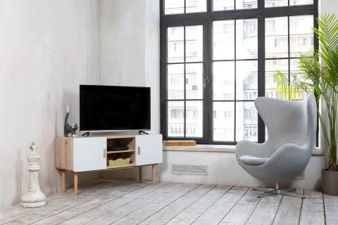 TV in the interior in loft style on the bedside table Stock Photos