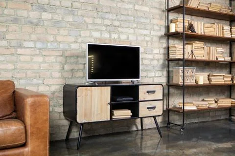 TV in the interior in loft style on the bedside table Stock Photos