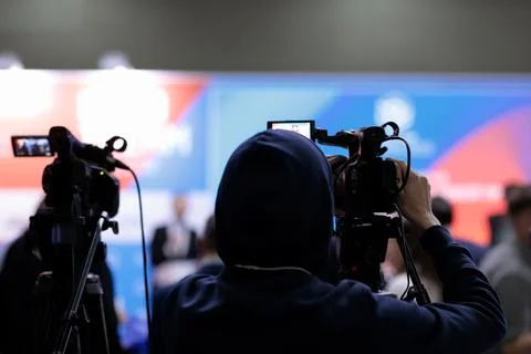 TV news camera operator broadcasting live event Stock Photos