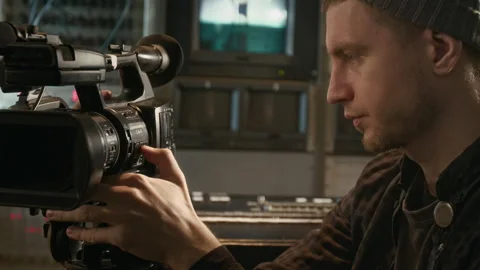 TV News Crew Operator Setting Up Camera for Recording Episode in Trailer Stock Footage 300401482