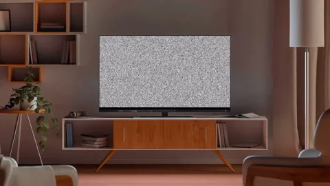 TV with noise and glitch on screen stands on wooden table Stock Footage 264084392