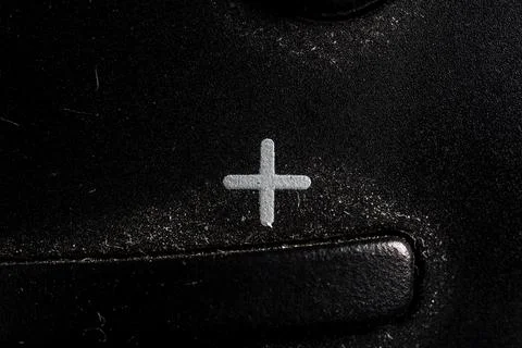 Tv plus icon and button close up of a old black Television remote controller Stock Photos