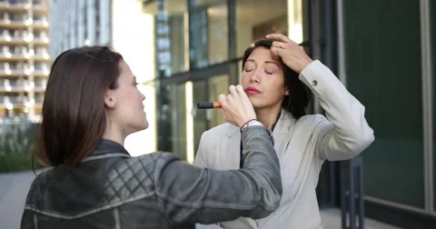 TV presenter having make-up applied on location Stock Footage 82116447