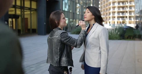 TV presenter having make-up applied on location Stock Footage 82118742