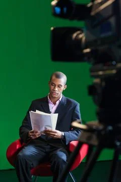 Tv presenter reads scripts Photos