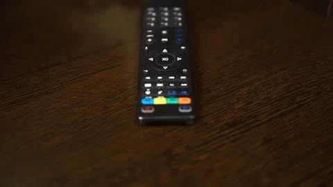 The TV remote on a brown table Stock Footage 104369249