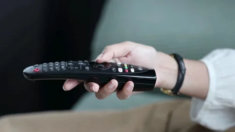 TV remote control close-up. Change channels on the TV using remote control. Stock Footage 257874244