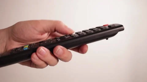 TV remote control closeup Fingers press buttons White background Stock Footage 146449072