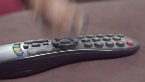 Tv remote control hand change channels press buttons zapping suffering idleness Stock Footage 241376119