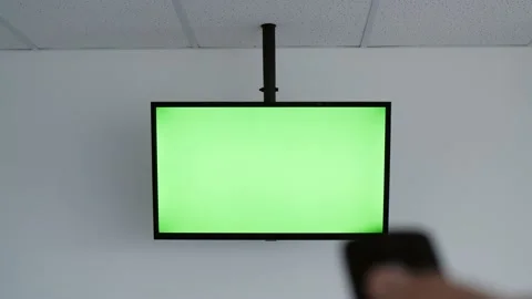 TV remote control. LED TV with green screen. Video stock 143605071