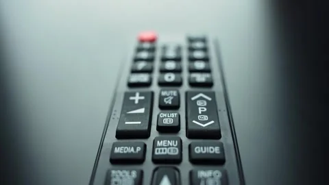 TV remote control lying on a dark surface with shallow depth of field and copy Stock Footage 331488046