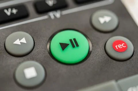 Tv remote control with play button. Concept of entertainment, fun, and news. Stock Photos