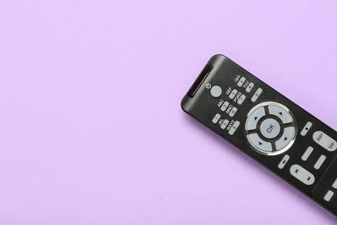 TV remote control on purple background Stock Photos