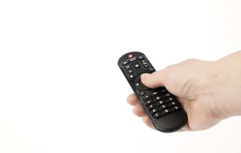 The TV remote control. The remote control in a woman's hand. The concept of Stock Photos