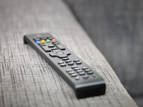 Tv remote control on sofa Фото