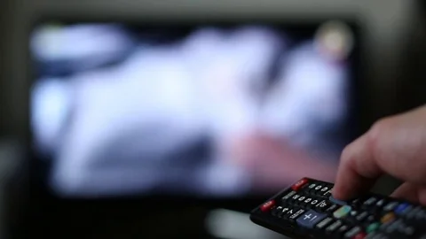 TV remote control surfing channels on television Stock Footage 71613249