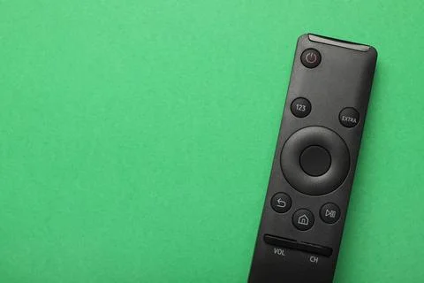 TV remote controller on green background 库存照片