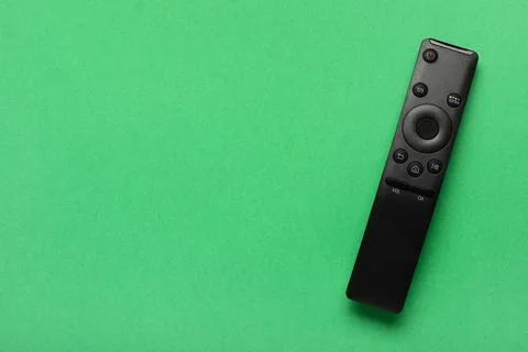 TV remote controller on green background 库存照片