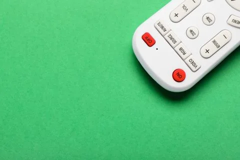 TV remote controller on green background 库存照片