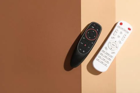 TV remote controllers on color background 库存照片