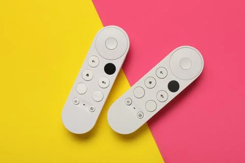 TV remote controllers on color background 库存照片