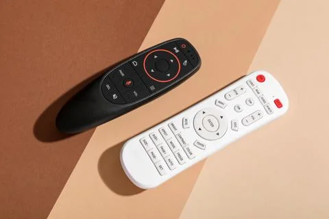 TV remote controllers on color background 库存照片