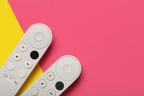 TV remote controllers on color background 库存照片