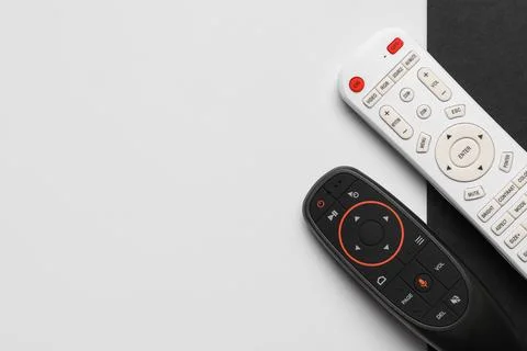 TV remote controllers on white and black background 库存照片