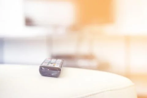 TV remote on the couch. Stock Photos