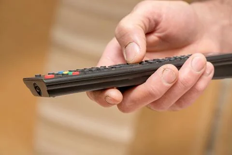 TV remote in the hand of man 스톡 사진