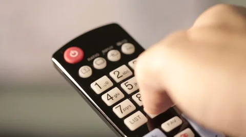 TV remote pointed at screen with fingers on buttons Stock Footage 54123815