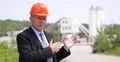 TV Reporter Talking Front of Camera About Concrete Factory Business Opportunity 4k or 4k+ Resolution