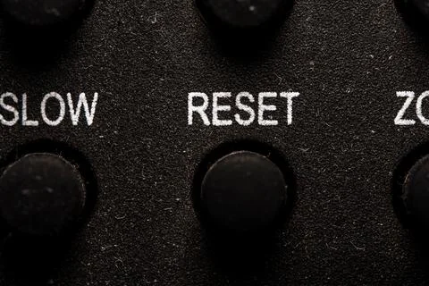 Tv reset icon and button close up of a old dusty black Television remote co.. Stock-Fotos