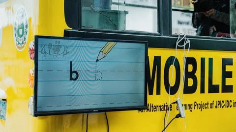 TV screen displaying alphabets on school bus Foto stock