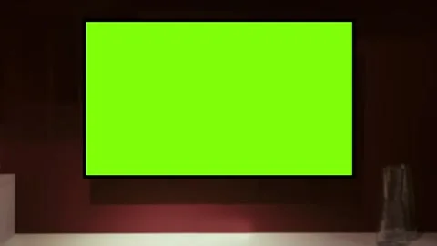TV screen mockup background. Lcd tv monitor with blank green screen in living Stock Footage 341392825