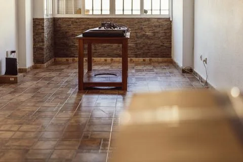 TV set lying on a table in an empty living room Stock Photos