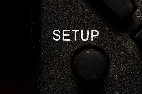 Tv setup icon and button close up of a old dusty black Television remote co.. Stock Photos