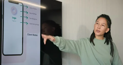 TV showing app mockup non-binary African lead wearing mint top explaining app, Stock Footage 342033145