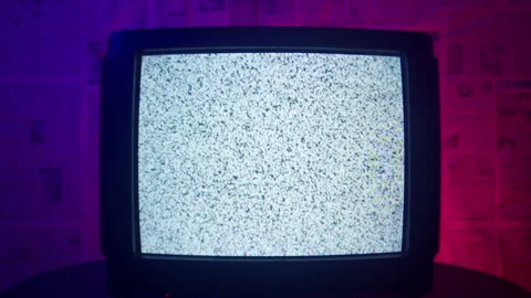 A TV with static noise stands in a dark blue and red room. Stock Footage 221623522