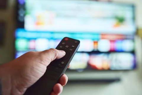 TV time with remote in hand Stock Photos